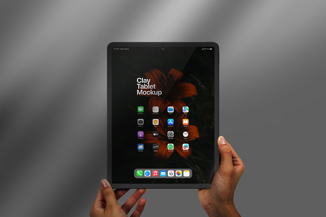 Photorealistic clay iPad Pro tablet PSD mockup held by two hands against a soft grey background, showing customizable screen and subtle reflections.