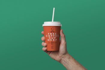 Free coffee cup mockup with hand holding takeaway paper cup for coffee shop branding and packaging.