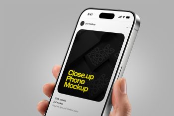 iPhone mockup with hand holding phone close-up showing editable screen for mobile app presentation.