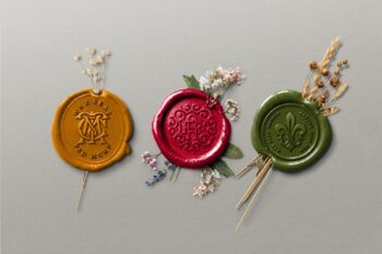 Botanical wax seal mockup showing three vintage wax stamps in mustard, burgundy and olive with dried botanicals on a gray background.