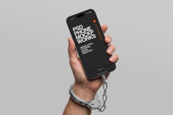 Handcuffed to phone mockup showing a hand holding an iPhone with a metal handcuff and chain locking the wrist to the device.