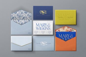 Wedding invitation envelope mockup flat-lay with blue, navy, yellow and orange envelopes, printed floral liners and a matching invitation card.