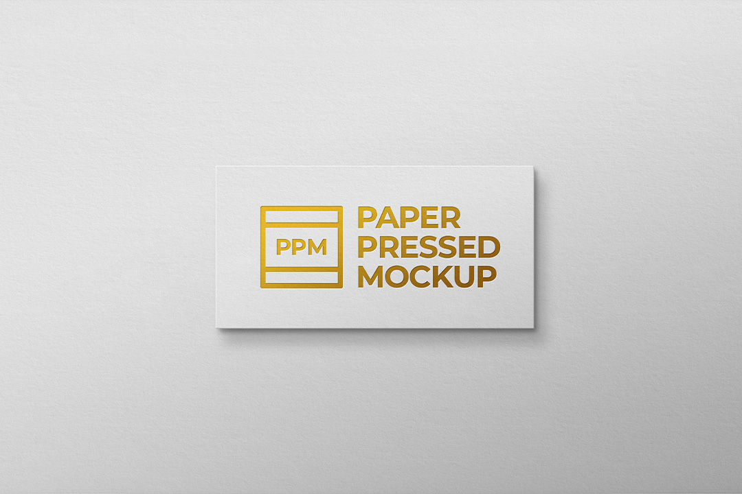 Gold letterpress logo mockup with a gold mark pressed into a white card resting on textured paper