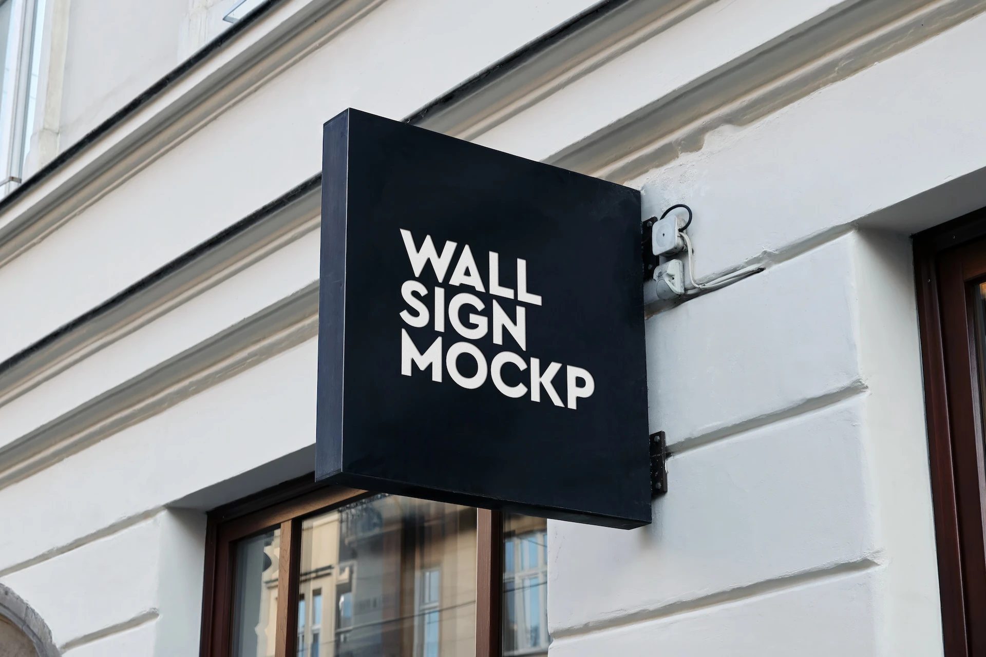 Wall sign mockup set black square hanging sign on a white facade above a shop window with wooden frame